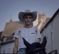 a man riding on the back of a black horse