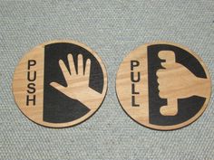 two wooden signs that say push, pull and hand with a wrench on them