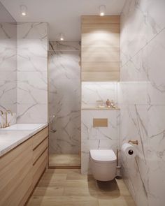 a white toilet sitting next to a wooden cabinet in a bathroom on top of a hard wood floor