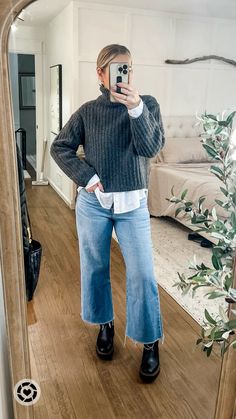 What I wore to work as a teacher in the snow. Loving these cropped wide leg jeans bc the hem stays dry and my weatherproof laguna boots were perfect for the wet snow and sleet. Layer a chunky turtleneck over a white button and pull the hair back in a slick messy bun for a more polished look. Add chunky gold hoops to dress it up and throw on a black overcoat! Medium sweater and button down, tts jeans Follow my shop @emma_grace_blog on the @shop.LTK app to shop this post and get my exclusive app-only content! #liketkit #LTKstyletip #LTKworkwear #LTKmidsize @shop.ltk #chunkyknit #winteroutfit #widelegjeans #casualstyle https://liketk.it/4t0LP Sweatshirt And Wide Leg Jeans, Turtleneck Sweater Layering, White Chunky Chelsea Boots Outfit, Jeans And Big Sweater Outfit, Wide Leg Jeans Ankle Boots, Wide Leg And Boots, Cropped Flare Jeans Outfit Winter Casual, Cropped Jeans With Chelsea Boots, Wide Leg Jeans With Sweater Outfit