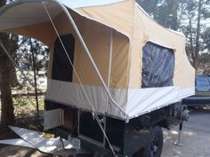 a tent is attached to the back of a truck