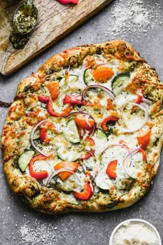 a pizza sitting on top of a wooden cutting board