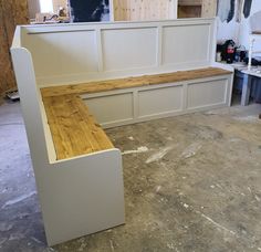 a bench made out of plywood is in the process of being built and installed