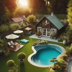 an aerial view of a pool surrounded by greenery and trees, with sun shining on the house