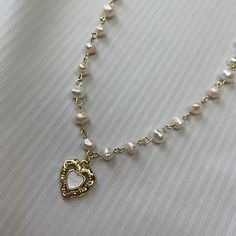 Aesthetic, soft-grunge, princessy pearl necklace made with real freshwater pearls, 18K gold-plated stainless steel and sterling silver 925. - Natural freshwater pearls - 18k Gold Plated sterling silver - Stainless Steel - Durable and hypo-allergic Jewellery 💎high quality, only precious materials 💘every jewelry piece is unique, handmade, one of a kind ✈️shipping worldwide (just press buy!) 💌beautiful packaging <3 Every order comes with free beautiful stickers matching the vibe of the necklace Length: 35-45 (13.7-18in) Gift option - Comes packaged beautifully in a gift bag, ready to be gifted to your loved one or as a treat for yourself Feel free to ask any questions🤍 🖤Shipping WORLDWIDE | FREE international shipping with orders of more than 1 item 🖤Feel free to ask any questions. I re Coquette Gold Jewellery, Pearl Aesthetic Necklace, Pearl Necklace With Pendant, Beads Necklace Aesthetic, Aesthetic Pearl Necklace, Pearl And Gold Jewelry, Cottage Jewelry, Girly Cottage, Heart Gold Necklace