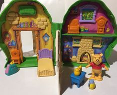 two toy houses with winnie the pooh figures