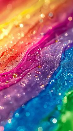 an abstract rainbow background with lots of water droplets on the top and bottom of it