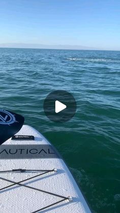 the front end of a kayak in the water with an arrow pointing towards it