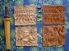 four different types of handmade leathers on a blue tablecloth with flowers and leaves