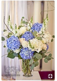 a vase filled with blue and white flowers