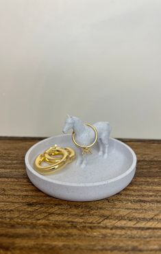 Elevate your jewelry organization with our Cute Horse Ring Dish, a unique and delightful accessory crafted for horse lovers. This charming piece doubles as a Horse Lover's Ring Tray and Horse Ring Holder, making it the perfect equine-inspired addition to your collection. 🎁 Product Details: Material: High-Quality Marble PLA plastic Dimensions: Length 3.5inches x Width 3.5inches x Height 2inches Color: Elegant Marble White 🌎 Conscious Crafting: We take pride in our environmentally conscious approach. Our items are 3D-printed with eco-friendly materials. 📸 Please Note: Accessories in Photos Not Included The product images may showcase accessories or additional items for decorative purposes only. Please be aware that the Ring/Earrings featured in the photos are not included with the purchas Western Wedding Ring Holder, Dog Ring Holder, Animal Ring Holder, Dinosaur Ring Holder, Horse Rings, Horse Ring For Women, Elephant Ring Holder, Dinosaur Jewelry, Horse Ring