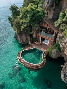 a house built into the side of a cliff with a pool in front of it