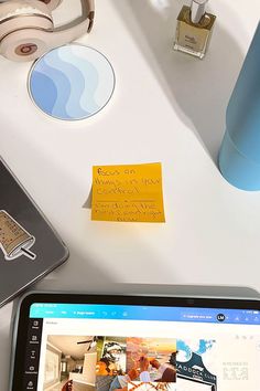 a laptop computer sitting on top of a white desk