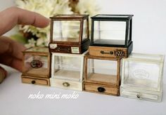 miniature boxes are stacked on top of each other in order to be used as jewelry holders