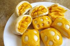 a white plate topped with yellow dices on top of a table