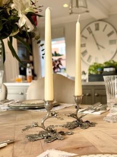 two candles sitting on top of a wooden table