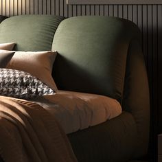 a bed with pillows and blankets on it in a room that has dark wood paneling