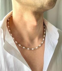 Mens Pearl Necklace with Gold Hematite, Pearl Necklace Men, Real Pearl Necklace for Men, Couples Necklace, Gifts for Men, Birthday Gift for Him, y2k Jewelry, Mens Necklace, Freshwater Pearl Necklace, Necklace for Men, Hematite Necklace, Mens Gold Necklace ♥ Useful Quick Notes * This product is prepared with ivory freshwater pearls, light gold shiny hematite stone beads and rhodium-plated ball beads. * The finish is made with a rhodium-plated lobster claw. * Length: We offer 2 options: 1. 49.3 cm(+-1) - 19.4 inch(+-0.4)  2. 53.8 cm(+-1) - 21.18 inch(+-0.4) You may choose free chain extension (5 cm - 2 inch) **The length may have difference up to 1 cm - 0.4 inch due to the natural shapes of the pearls. * Made of high quality rhodium plated over brass.  * For longer lasting use, it is recomme Pearl Necklace Boy, Pearl Necklace Aesthetic, Mens Pearl Necklace, Pearl Necklace Men, Preppy Necklaces, Pearl Necklace With Gold, Couples Necklace, Gold Necklace For Men, Real Pearl Necklace