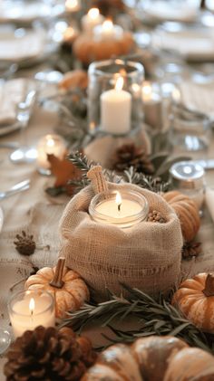 the table is set with candles and pumpkins