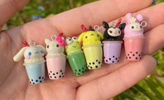 a person is holding several small toy items in their hand and they are all different colors