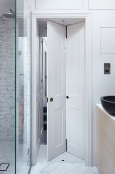 an open door leading to a bathroom with a black sink