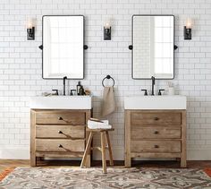 a bathroom with two sinks and mirrors on the wall