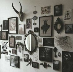 the wall is covered with many pictures and frames