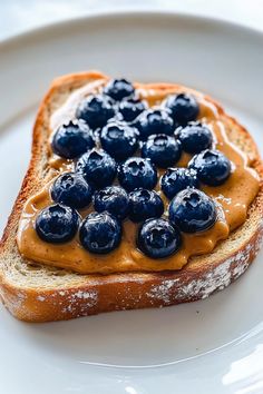 a piece of bread with blueberries and peanut butter on it