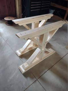 a wooden table sitting on top of a cement floor