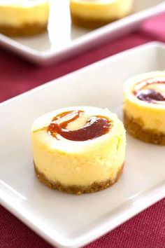 two small desserts are sitting on a white plate next to each other and one is filled with jelly