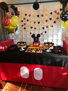 a mickey mouse themed birthday party with balloons