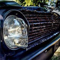 the front end of an old black car