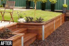 a wooden planter filled with lots of green grass and plants on top of it