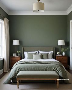 a bedroom with green walls and white bedding, two lamps on either side of the bed