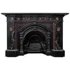 an ornate fireplace with black marble and red flowers on the mantel surround it is isolated against a white background