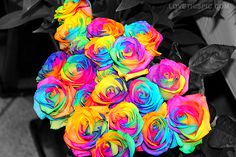 a bouquet of multicolored roses sitting on top of a table