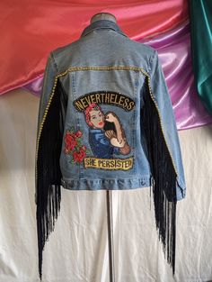 a denim jacket with an image of a woman on it