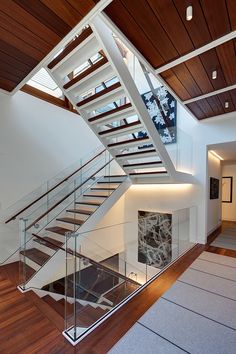 the stairs are made of glass and wood