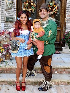 a man, woman and child dressed up in costumes