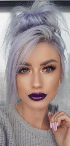 a woman with grey hair and purple lipstick