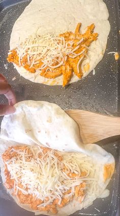 two uncooked tortillas being prepared on a baking sheet