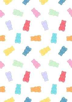 colorful gummy bears are scattered on a white background with blue, yellow, pink, and green