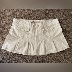 Y2k Hollister Light Beige Khaki Low Rise Micro Mini Pleated Skirt Front Pockets! Button Zip Closure. Excellent Condition, Washed Once, Air Dried , Never Worn. Size 7 Waist Flat Across: 16 1/2” Front Length: 11” Back Length: 12” Last Picture Is To Show Color Comparison With A Tan Khaki Skirt. Y2k Cargo Skirt With Pockets For Spring, Fitted Y2k Skirt With Pockets, Y2k Fitted Skirt With Pockets, Spring Y2k Cargo Skirt With Pockets, Y2k Mini Cargo Skirt For Spring, Y2k Style Fitted Skirt With Pockets, Y2k Style Mini Cargo Skirt For Spring, Y2k Mini Skirt With Pockets, Y2k Style Mini Skirt For Spring