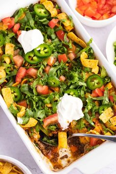 a white casserole dish filled with mexican food