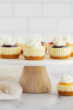 small cupcakes with white frosting on a cake stand