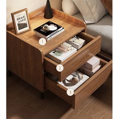 a wooden table with drawers on top of it and some books in the bottom drawer