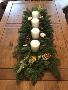 the table is decorated with candles and greenery