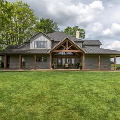 a large house sitting on top of a lush green field