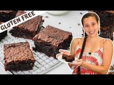 a woman holding a plate with brownies on it and the words gluten free