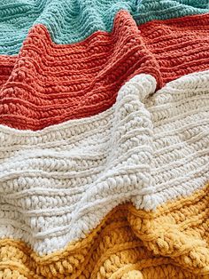 there are many different colors of knitted blankets